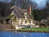 Park of the Palace of Versailles - Hameau de la Reine: Grand Lac and house with thatched roof