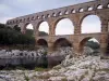 Pont du Gard bridge - Roman aqueduct (ancient monument) with three levels of arcades (arches) spanning the River Gardon; in the town of Vers-Pont-du-Gard