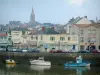 Pornic - Fishing port with its boats and its trawlers moored to the quay, the church and houses of the city (seaside resort)