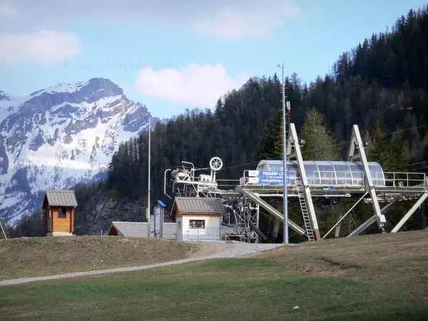 Pra-Loup - Ski lift (chairlift) of the ski resort, trees and mountain