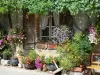 Pujols - Façade d'une maison décorée de pots de fleurs