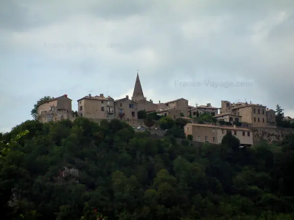 Puycelsi - Hilltop village (Albigensian fortified town) overhanging the forest and cloudy sky