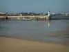Ré island - La Flotte: sandy beach of the village (seaside resort) at ebb tide with view of the lighthouse in the port