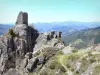 Rochebonne castle - Ruins of the castle in the town of Saint-Martin-de-Valamas, in the Regional Natural Park of the Ardèche Mountains: tower perched on a rocky outcrop with a view of the surrounding green landscape