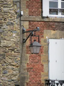 Rocroi - House facade adorned with a wall lantern