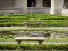 Royaumont abbey - Medieval-inspired garden (nine-square garden) and its plants, facade of the royal abbey and trees; in the town of Asnières-sur-Oise, in the Oise-Pays de France Regional Nature Park