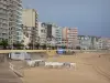 Les Sables d'Olonne - Praia de areia, aterro, andar com palmeiras e edifícios da estância balnear