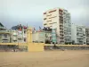 Les Sables d'Olonne - Praia de areia, relógio (torre), bandeiras, casas e edifícios da estância balnear