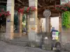 Saint-Antonin-Noble-Val - Flower-bedecked covered market hall and discoid stele (croix de la halle)