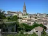 Saint-Émilion - Bell tower of the monolithic church overlooking the houses of the medieval town 