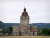 Saint-Hymetière church - Romanesque church with its octagonal bell tower, cemetery, fields and hills covered with trees in background