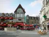 Saint-Quentin - Flower-bedecked fountain, cafe terraces, shops and facades of the town