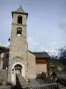 Saint-Véran - Bell tower of the Protestant temple (reformed church), houses of the mountain village and snowy mountain (snow)