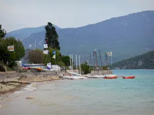 Sainte-Croix lake - Water sports centre (catamarans, boats) of the Sainte-Croix-du-Verdon village, emerald-coloured lake (water reservoir) and hills; in the Verdon Regional Nature Park