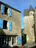 Sainte-Suzanne - Turret of the Sainte-Suzanne church and stone house with blue shutters
