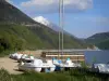 Sautet lake - Water sports centre with its pedal boats on the bank, artificial lake and mountains; in the Trièves