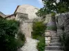 Simiane-la-Rotonde - Narrow street of the village lined with flowers and vegetation