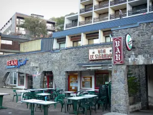 Super Besse - Bar terrace and buildings of the ski resort (winter sports); in the Auvergne Volcanic Regional Nature Park, in the Massif du Sancy mountains (Monts Dore), in Besse -et-Saint-Anastaise