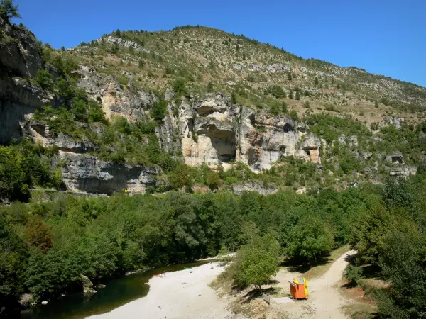 Tarn gorges - Cirque de Saint-Chély rock formations: beach, River Tarn lined width trees, and limestone cliffs overlooking the place; in the Cévennes National Park