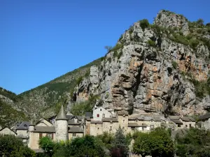 Tarn gorges - Castle (Montesquiou manor) and houses in the village of La Malene at the foot of the La Barre rock; in the Cévennes National Park