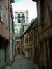 Troyes - Narrow paved street lined with old timber-framed houses, view of the tower of the Sainte-Madeleine church