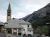 Val-des-Prés - Saint-Claude church with its bell tower and its porch, cemetery and mountain; in the Clarée valley