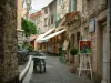 Vence - Narrow street lined with an art gallery, with a restaurant terrace and with a shop selling Provençal specialities
