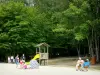 Vieilles-Forges lake - Wooded shore of the lake with a playground for children