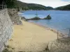 Villefort lake - Sandy beach, lake and mountains; in the Cévennes National Park